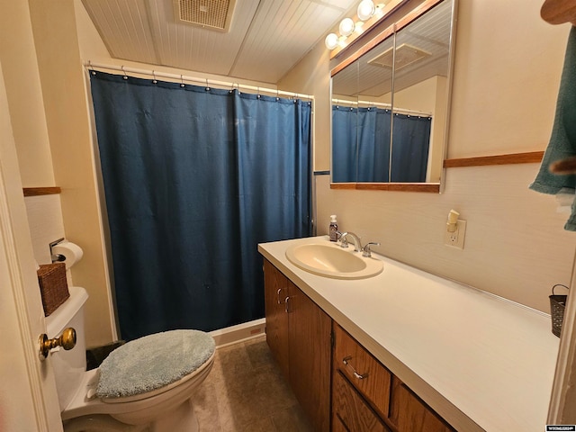 bathroom with vanity, tile patterned flooring, and toilet