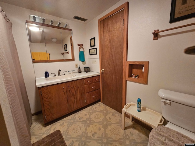 bathroom with vanity, tile patterned flooring, and toilet