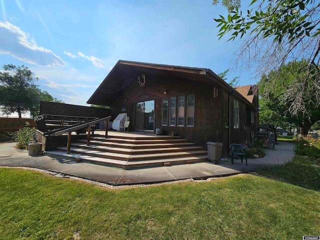 back of house featuring a patio and a lawn