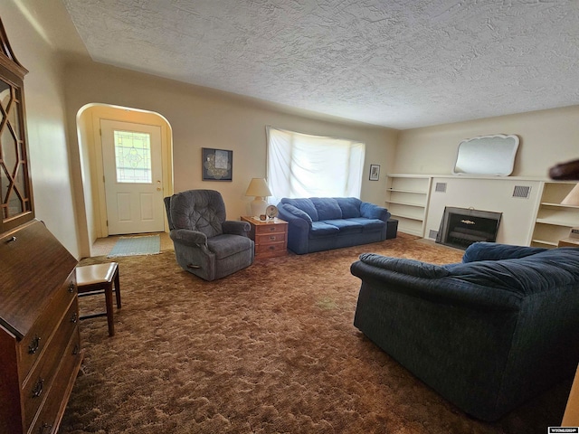 living room featuring a textured ceiling and carpet flooring