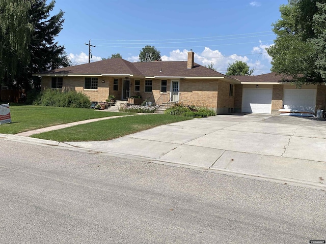 ranch-style home featuring a garage and a front lawn