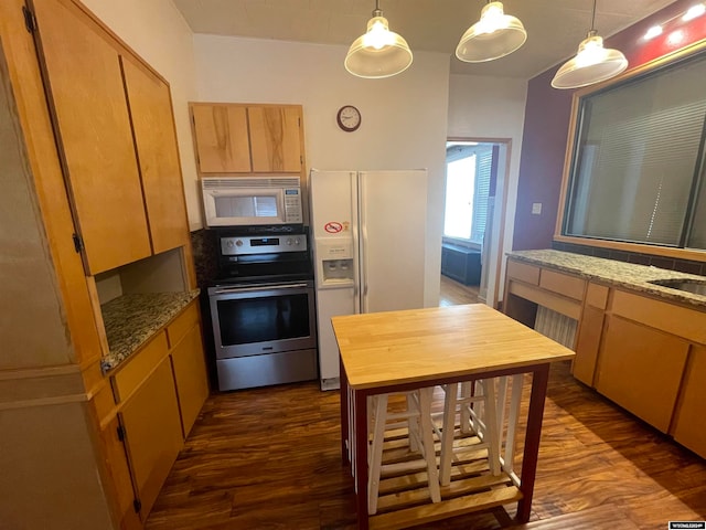 kitchen featuring pendant lighting, wood-type flooring, light stone counters, and white appliances