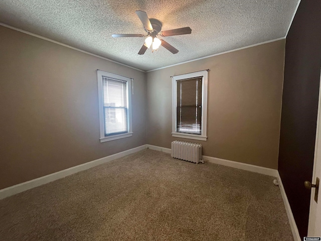 spare room featuring a textured ceiling, ceiling fan, carpet flooring, and radiator