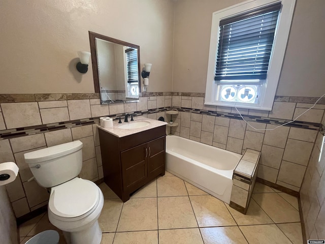 bathroom with vanity, tile patterned floors, toilet, and tile walls