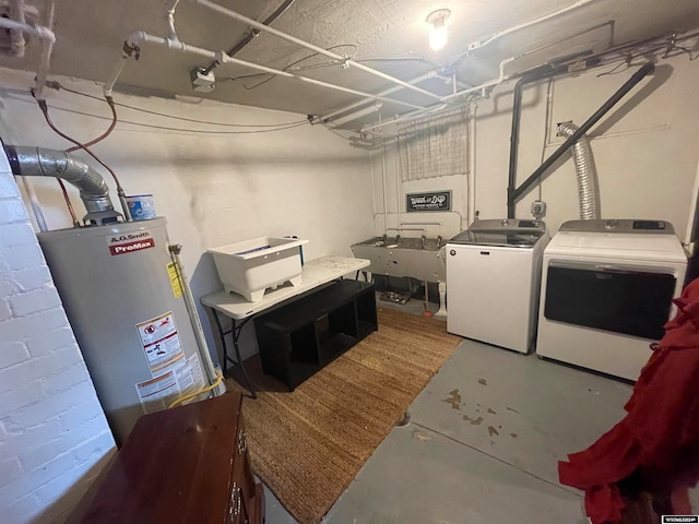 laundry area featuring sink, washing machine and dryer, and water heater