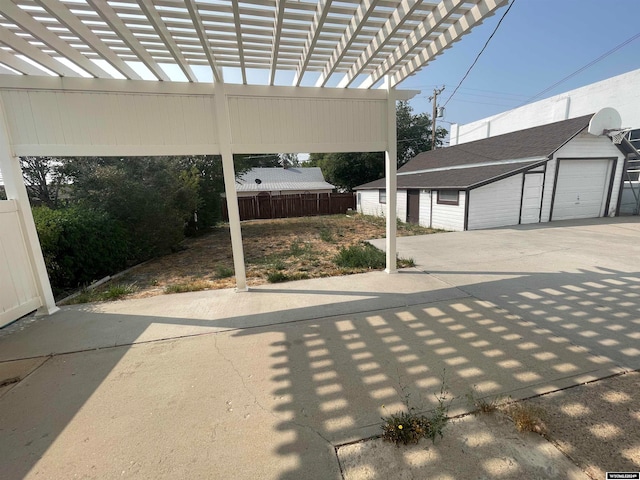 exterior space with a pergola, an outbuilding, and a garage