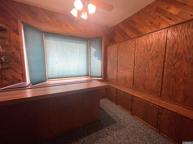 interior space featuring wood walls, carpet, and wood ceiling