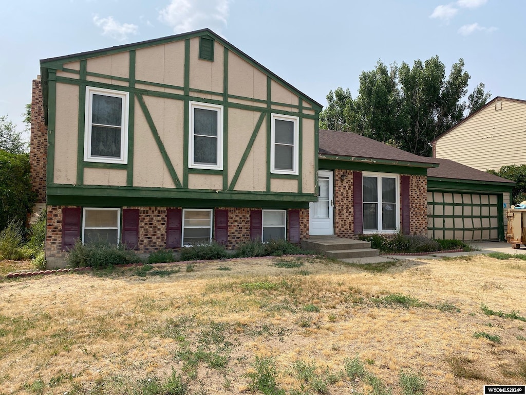 view of front of property featuring a garage and a front lawn