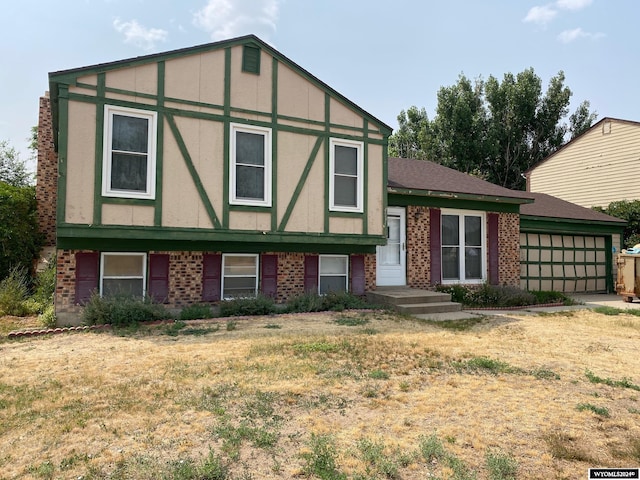 view of front of property featuring a garage and a front lawn