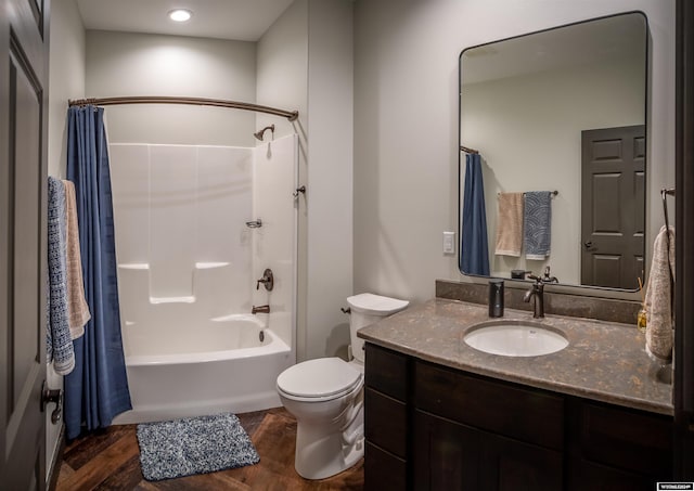 full bathroom with vanity, shower / bathtub combination with curtain, toilet, and wood finished floors