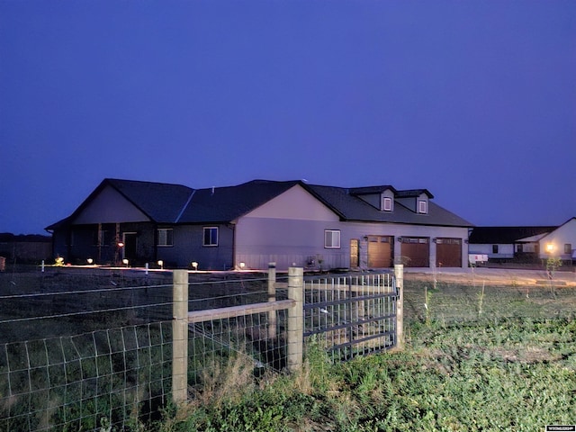 view of front of home featuring a garage and fence