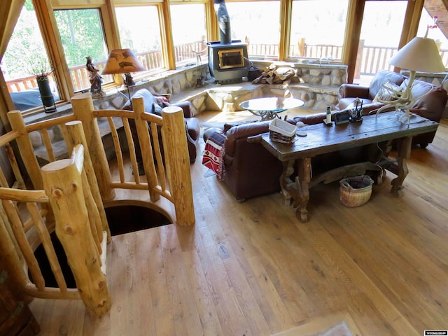 living room featuring light hardwood / wood-style flooring and a wood stove