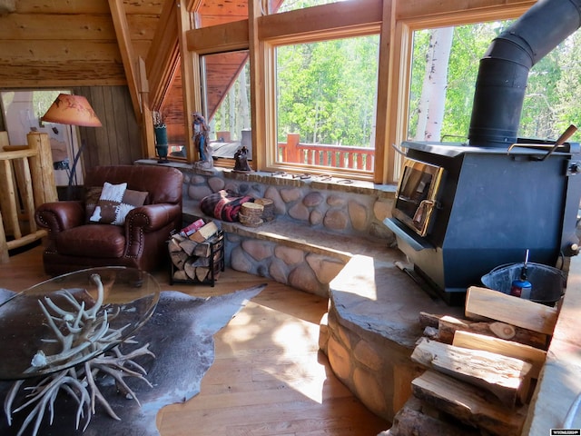 living room with a wood stove and hardwood / wood-style floors