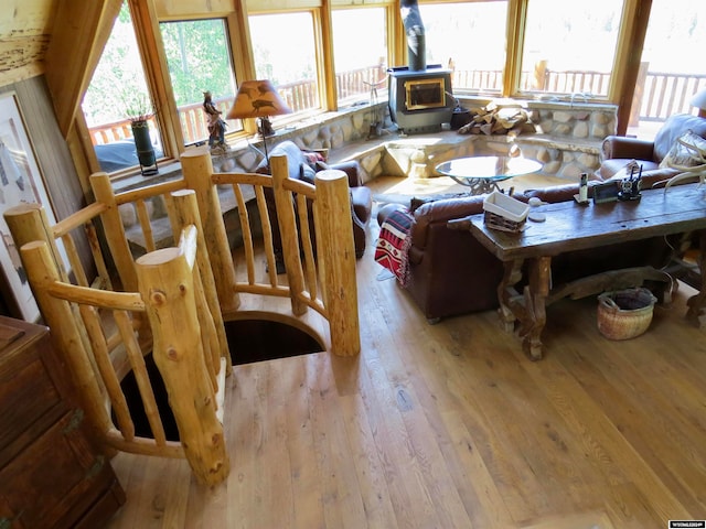 living room featuring light hardwood / wood-style flooring and a wood stove