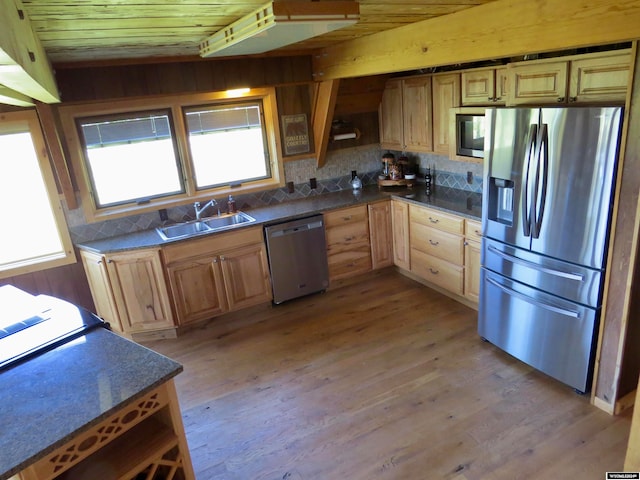 kitchen featuring appliances with stainless steel finishes, light hardwood / wood-style flooring, tasteful backsplash, sink, and wooden ceiling