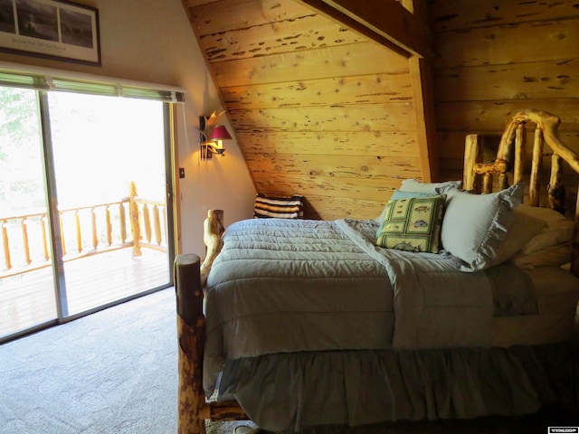 bedroom featuring access to exterior, wood walls, carpet, and vaulted ceiling