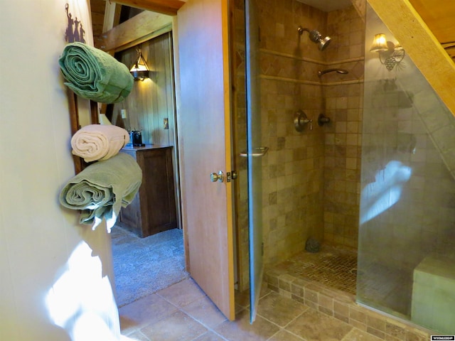 bathroom with a shower with shower door and tile patterned floors