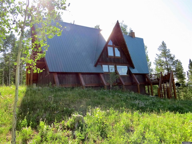 rear view of house featuring a deck