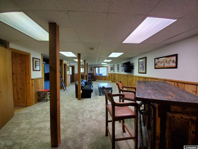 dining room with a drop ceiling and light carpet