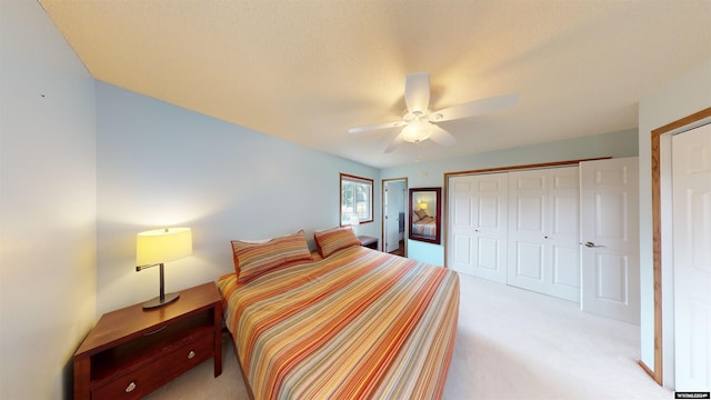 bedroom featuring ceiling fan, a closet, and light carpet