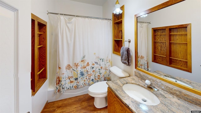 full bathroom with shower / bath combo with shower curtain, wood-type flooring, toilet, and vanity