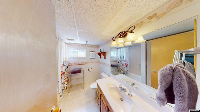 bathroom featuring vanity, toilet, and a paneled ceiling