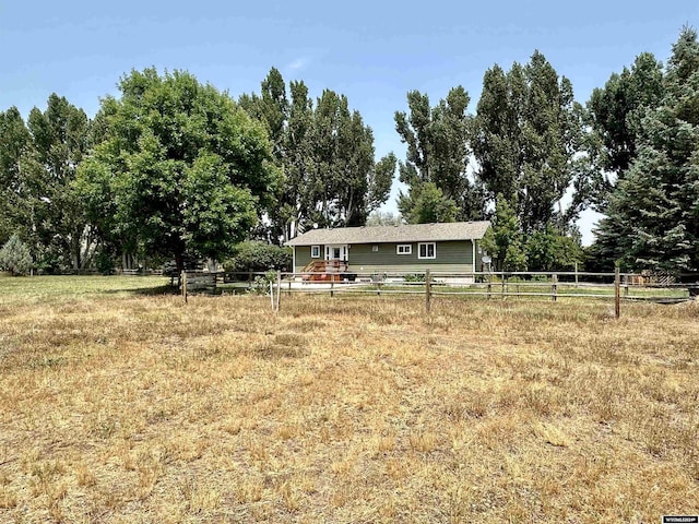 view of yard with a rural view