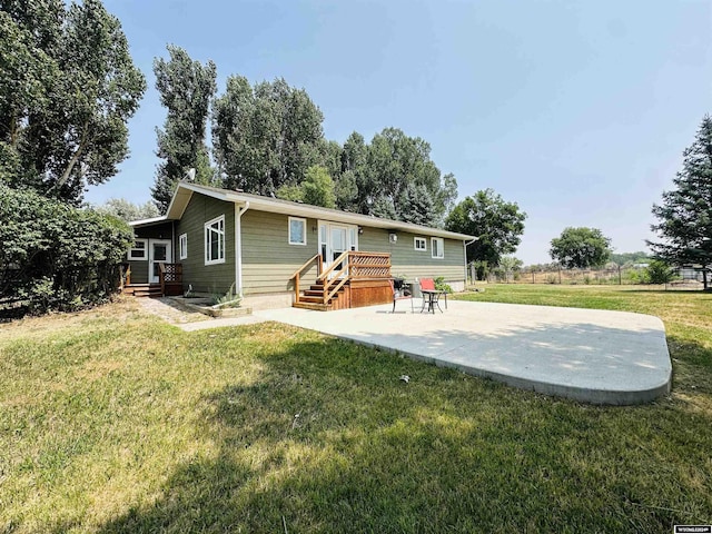 back of house featuring a patio and a lawn