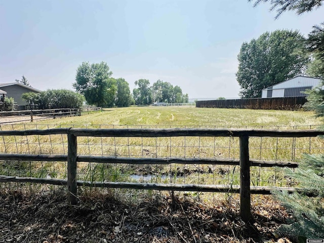 view of yard with a rural view