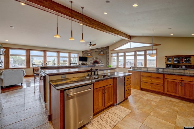 kitchen featuring a sink, open floor plan, stainless steel dishwasher, and decorative light fixtures