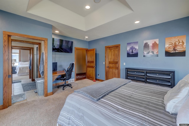 bedroom with light carpet, a tray ceiling, recessed lighting, and baseboards