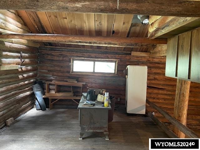 interior space featuring dark wood-type flooring, wooden ceiling, vaulted ceiling, and rustic walls