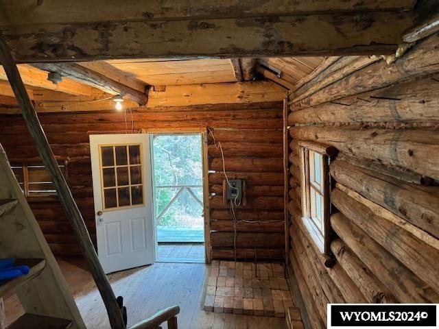 interior space with wood ceiling, lofted ceiling with beams, and hardwood / wood-style floors