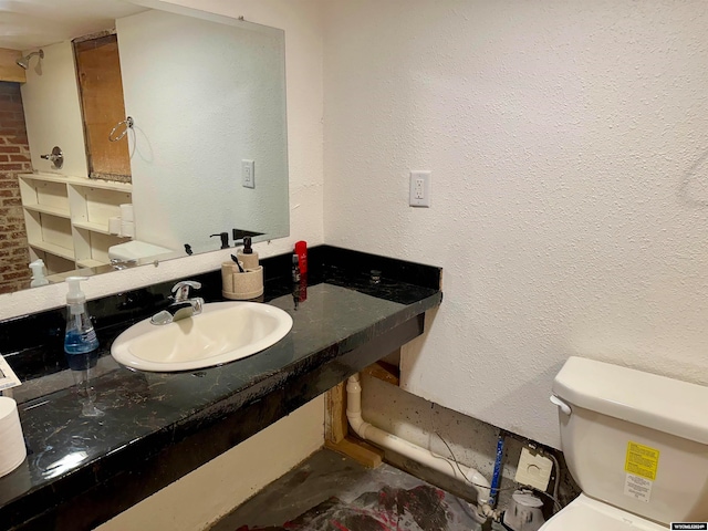 bathroom with toilet and vanity