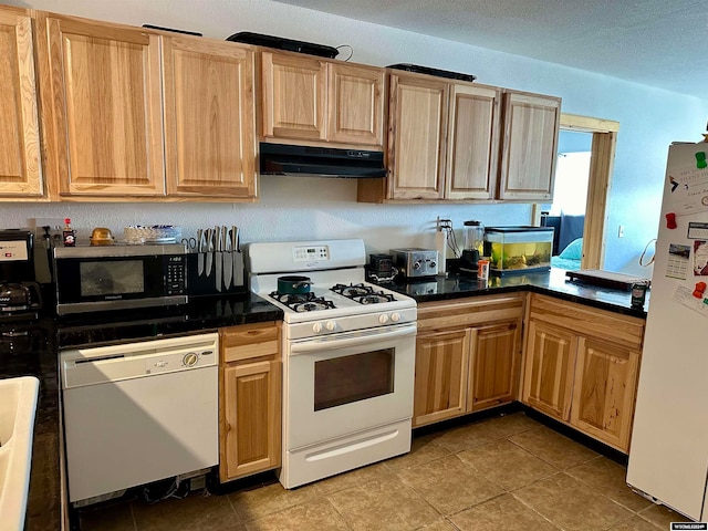 kitchen with white appliances and light tile patterned floors