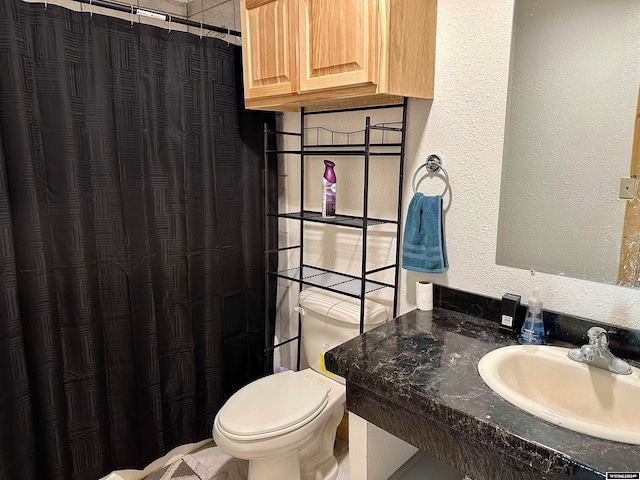 bathroom featuring tile patterned floors, toilet, and vanity