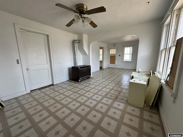 unfurnished living room with ceiling fan