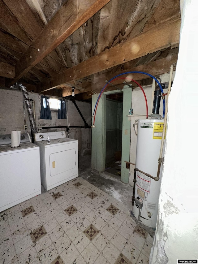 basement with water heater and washer and dryer