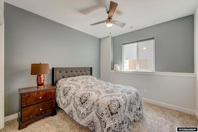 carpeted bedroom with visible vents, baseboards, and ceiling fan