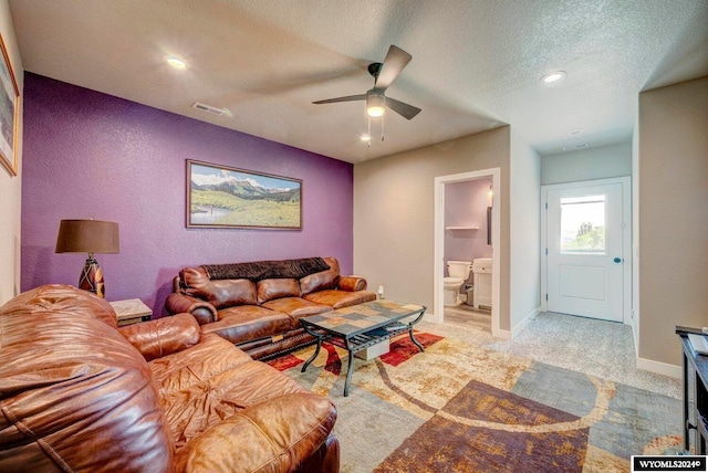 carpeted living area with visible vents, a ceiling fan, a textured ceiling, recessed lighting, and baseboards