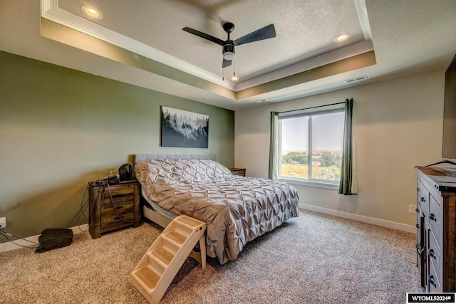 bedroom with visible vents, a raised ceiling, a textured ceiling, carpet, and baseboards