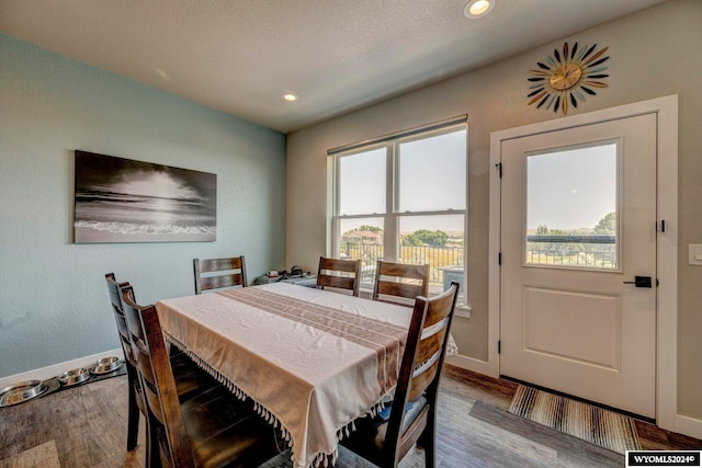 dining room featuring recessed lighting, baseboards, and wood finished floors