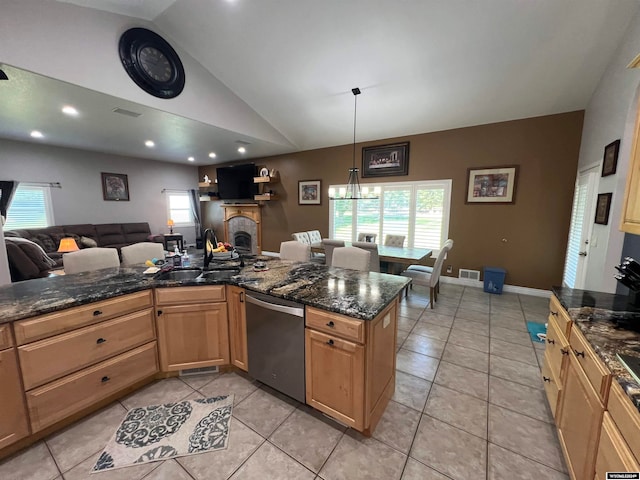 kitchen featuring dark stone countertops, stainless steel dishwasher, vaulted ceiling, and light tile patterned floors