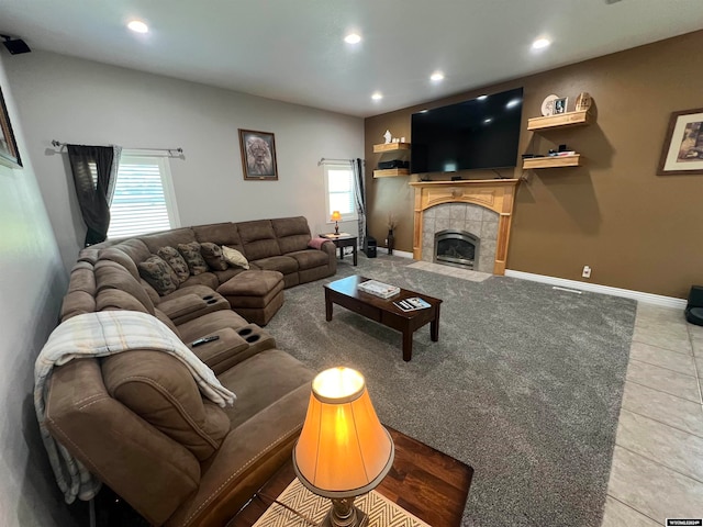 living room with light tile patterned flooring and a tile fireplace