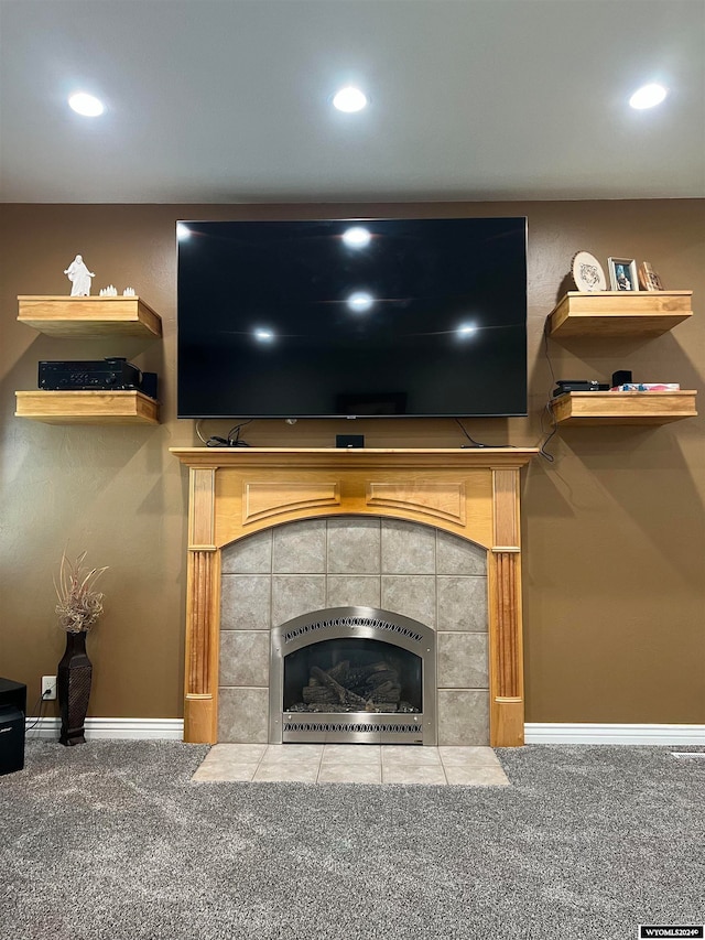 living room with a fireplace and carpet