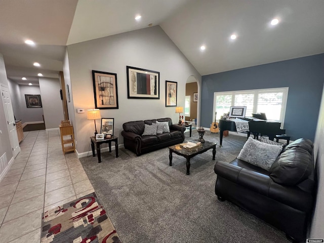 living room with high vaulted ceiling and light tile patterned floors