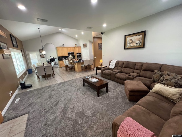 living room featuring light tile patterned flooring and lofted ceiling