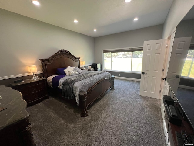 bedroom with multiple windows and carpet floors