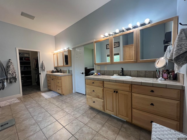 bathroom with tile patterned flooring and vanity