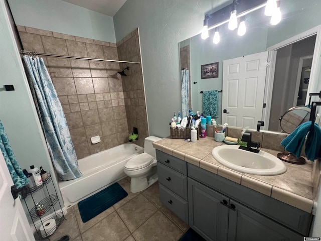 full bathroom with shower / tub combo with curtain, vanity, tile patterned flooring, and toilet